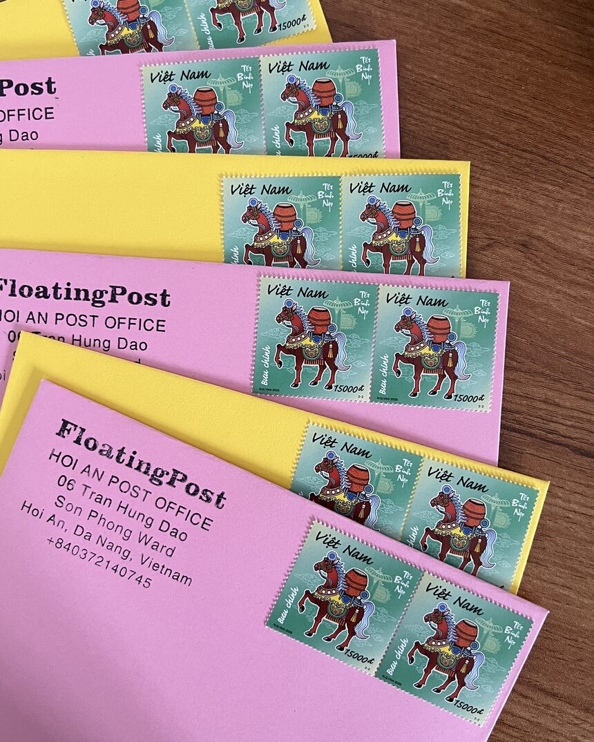 Pink and yellow envelopes with the FloatingPost Hội An return address and Vietnamese horse stamps