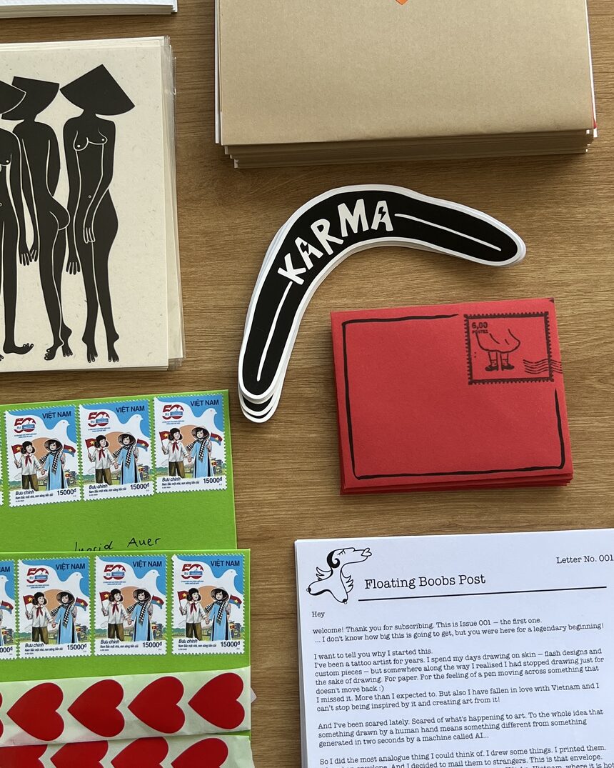 Floating Post contents laid out — Karma sticker, red boob-stamp envelope, Vietnamese stamps, heart stickers and the welcome letter